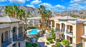 A resort with multiple buildings, a central swimming pool, and palm trees. - Casa La Quinta ~ Luxury Condo w/Pool near Old Town (La Quinta)