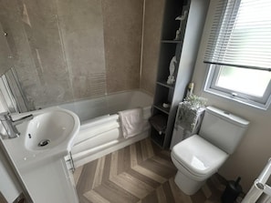 Combined shower/bathtub, deep-soaking bathtub, towels