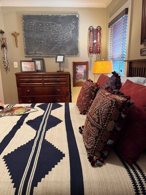A bedroom with a bed, a dresser, a map of the United States on the wall, and a window with blinds. - Spacious Craftsman Guest Suite in VA-Highland (Atlanta)