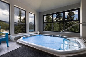 A modern indoor swimming pool with a view of trees and mountains through large windows. - Your Basecamp! Responsive host! Best deal! (Durango)