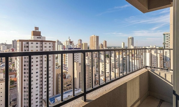 Un edificio alto con balcón que da a una vista panorámica de la ciudad.