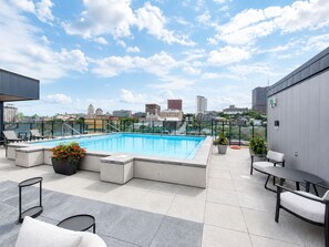 A rooftop pool area with a city view, seating, and a small table. - Secret Agent Suite | Rooftop Pool | Sleeps 6 (Québec)