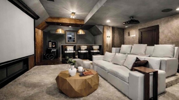 Un salon moderne avec un grand canapé blanc, une table basse et un ventilateur de plafond.