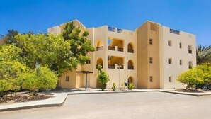 A multi-story building with a central courtyard, balconies, and greenery. - El Gouna luxury apartment lagoon and pool view (Hurghada 2)