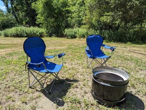 Two blue folding chairs and a metal barrel in an outdoor setting. - Secluded 6BR Retreat Near Lake Hopatcong (Roxbury Township)