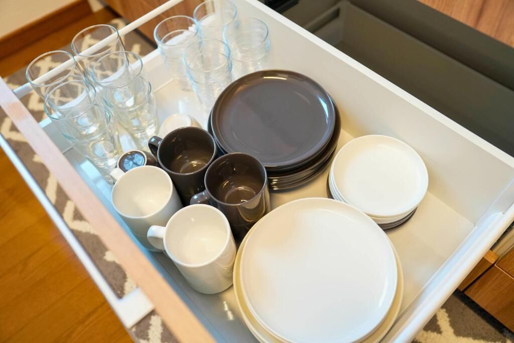 A tray with various glassware and plates, likely for a dining setup.
