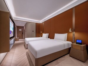 A hotel room with two beds, a bedside table with a lamp, and a digital screen. - Crystal Hotel Beijing TianTan (Beijing)