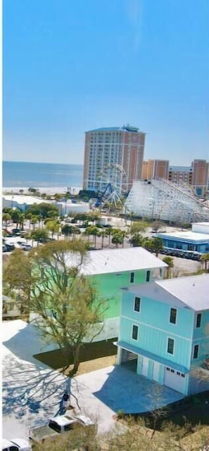 A coastal view with a beach, a roller coaster, and a multi-story building. - 1 Block to Beach • Balcony • Family-Friendly- The heart of Myrtle Beach (Myrtle Beach)