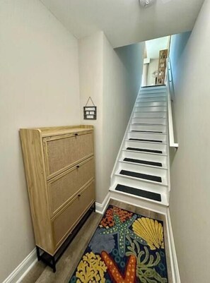A narrow hallway with a wooden cabinet and a colorful rug. - 1 Block to Beach • Balcony • Family-Friendly- The heart of Myrtle Beach (Myrtle Beach)
