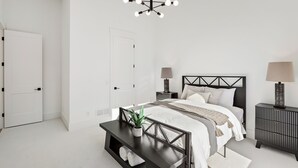 Et moderne soveværelse med seng, sengeborde, skrivebord og en hængende lampe.