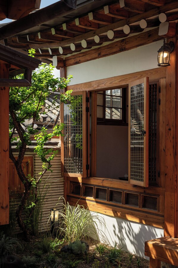 A traditional wooden building with a window and a wooden beam structure.