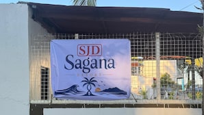 A banner for SJD Sagana Resort with a tropical design, including palm trees and waves. - SJD Sagana Resort (Macarthur)