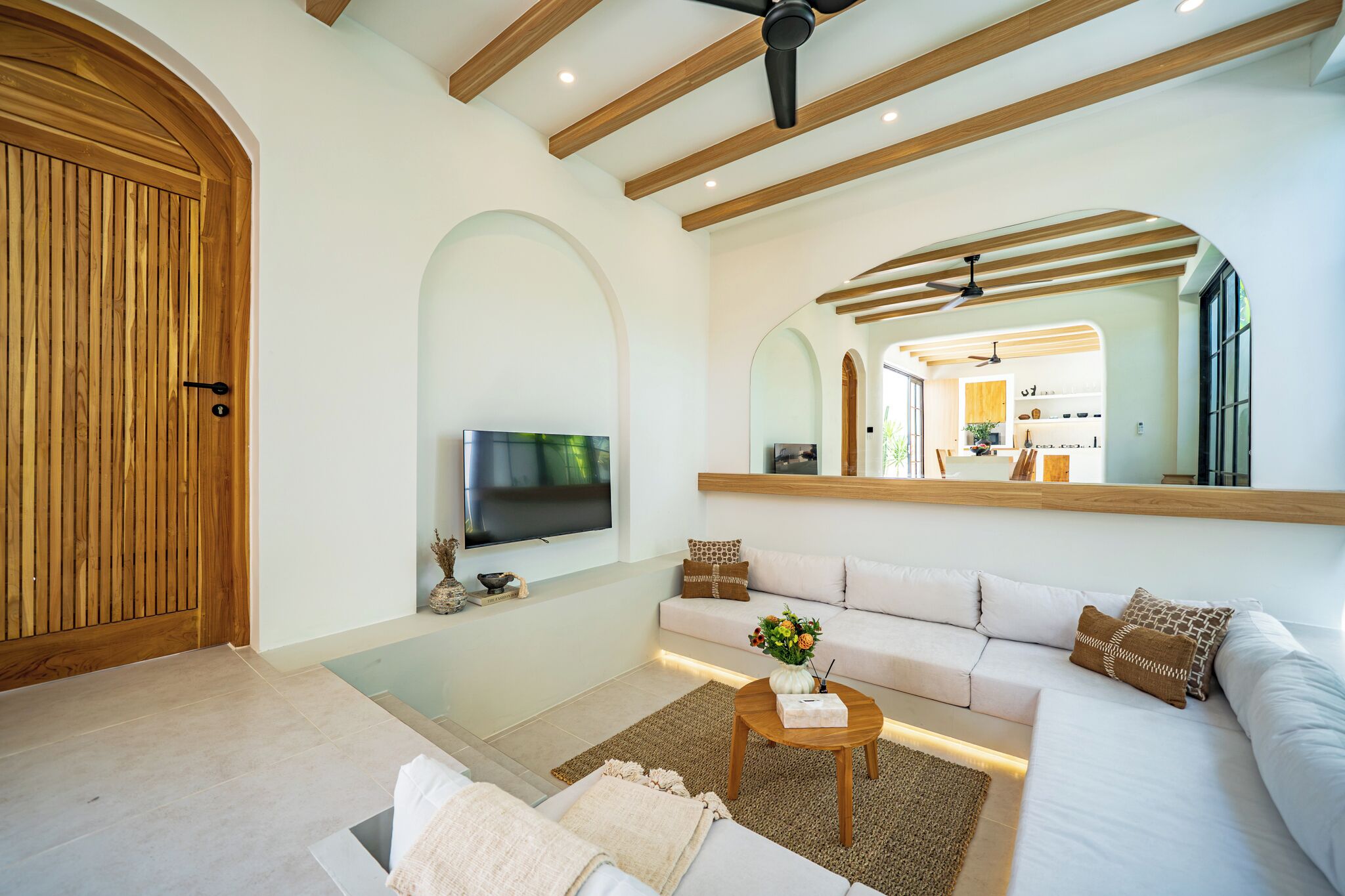 A modern living room with a television, sofa, and coffee table.