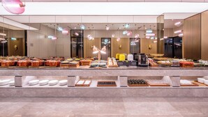 A modern hotel breakfast buffet with a variety of food options and a contemporary design. - Crystal Hotel  Beijing Guomao Heshenghui (Beijing)