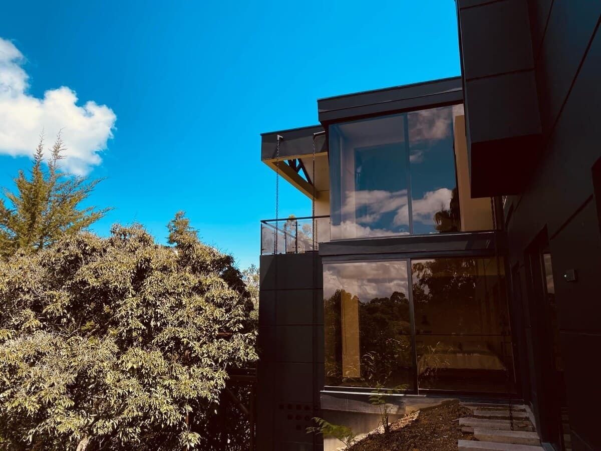A modern building with large glass windows and a balcony.