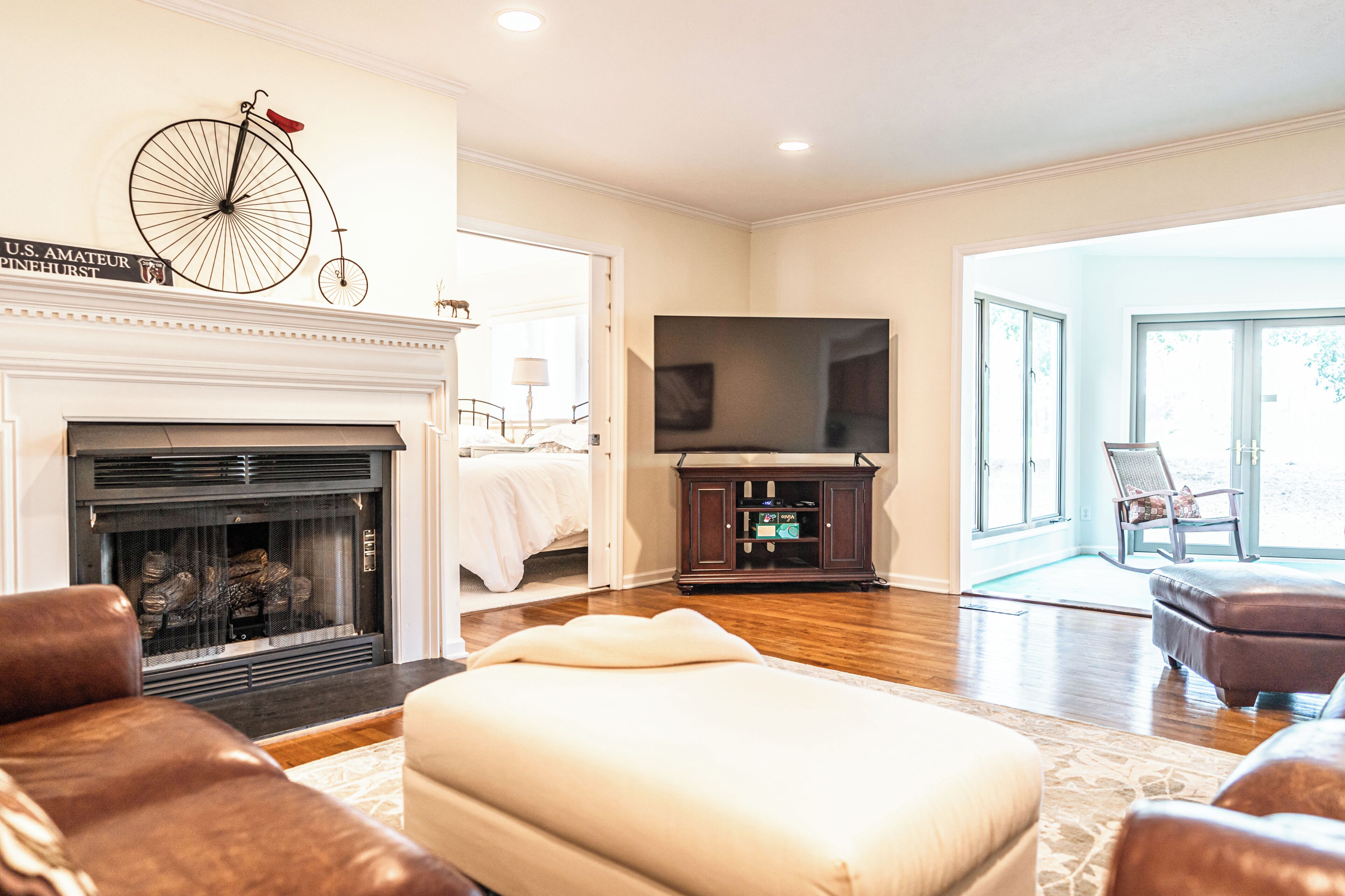 A living room with a fireplace, a television, and a seating area.