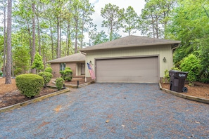 A residential property with a garage, a driveway, and a well-maintained lawn. - The Fairway Retreat on Pinehurst #5! (Pinehurst)