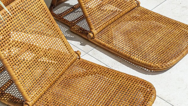 Two wicker lounge chairs with a woven seat and backrest, positioned on a tiled floor. - NAVA - Contemporary 3BR Villa (Badung)