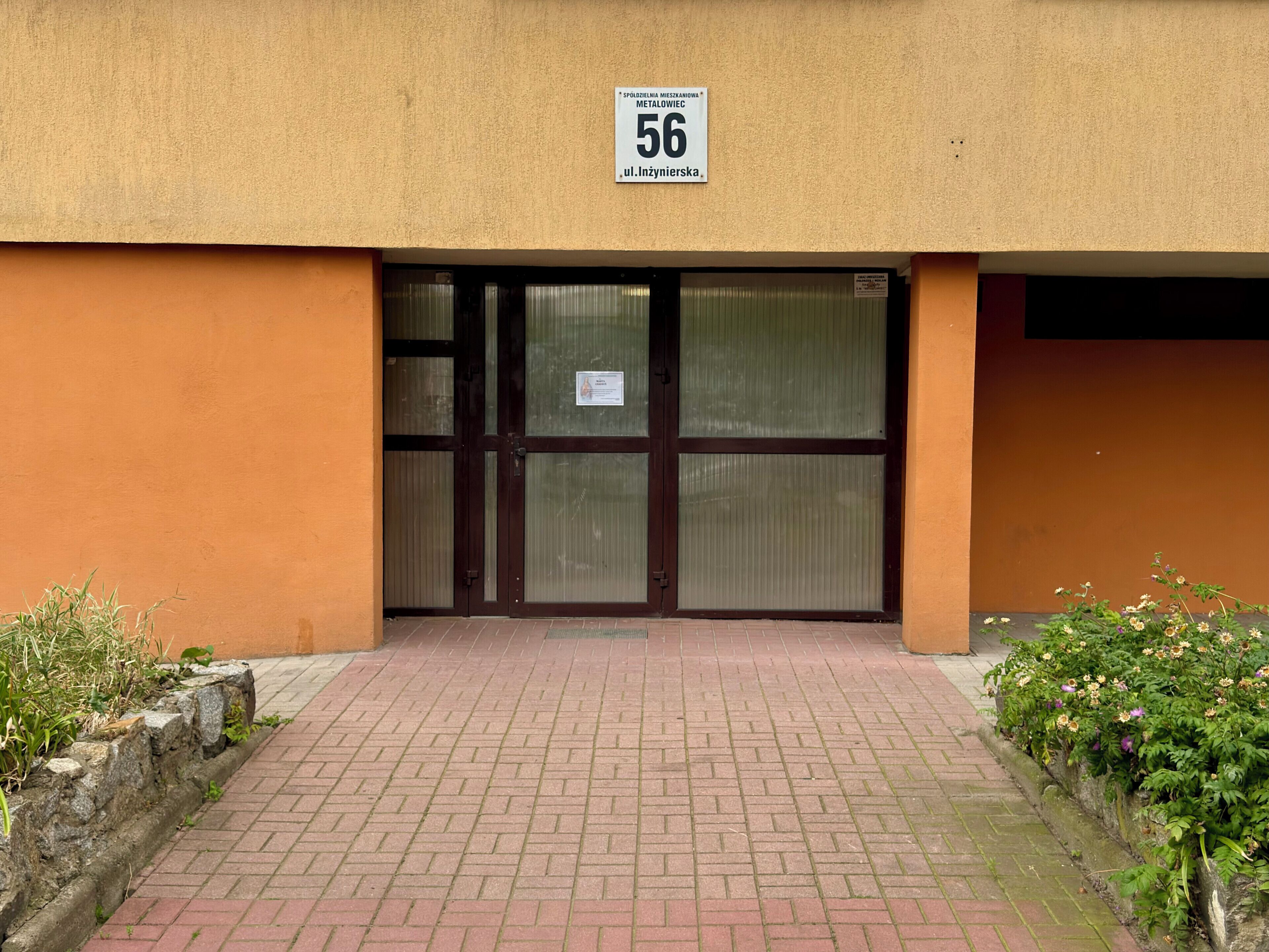 A building entrance with a sign indicating the address.