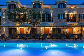 A stone building with a pool, outdoor seating, and multiple balconies. - Boutique Hotel Ruzmarin SPA & Garden (Budva)