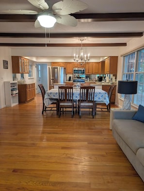 A spacious kitchen with wooden cabinets, a dining table with chairs, and a chandelier. - Beautiful & Spacious 3 bedroom/3 bath home with stunning views of Norfolk Lake (mountain home)
