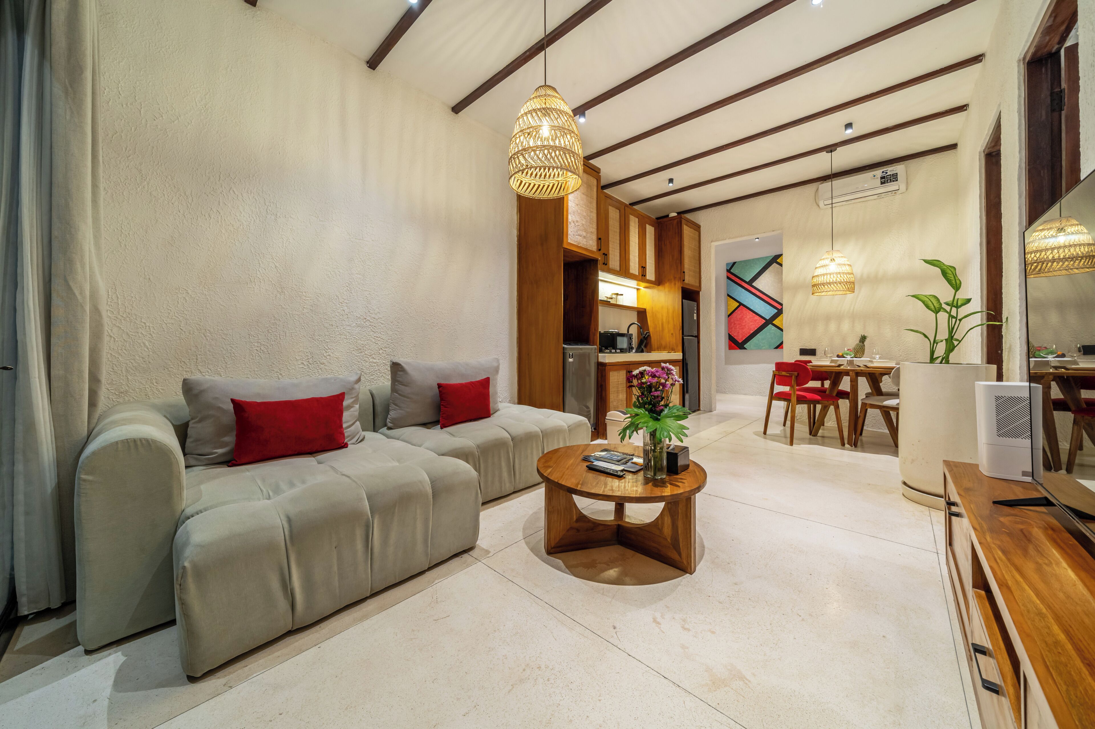 Una sala de estar moderna con sofá, mesa de centro y comedor.