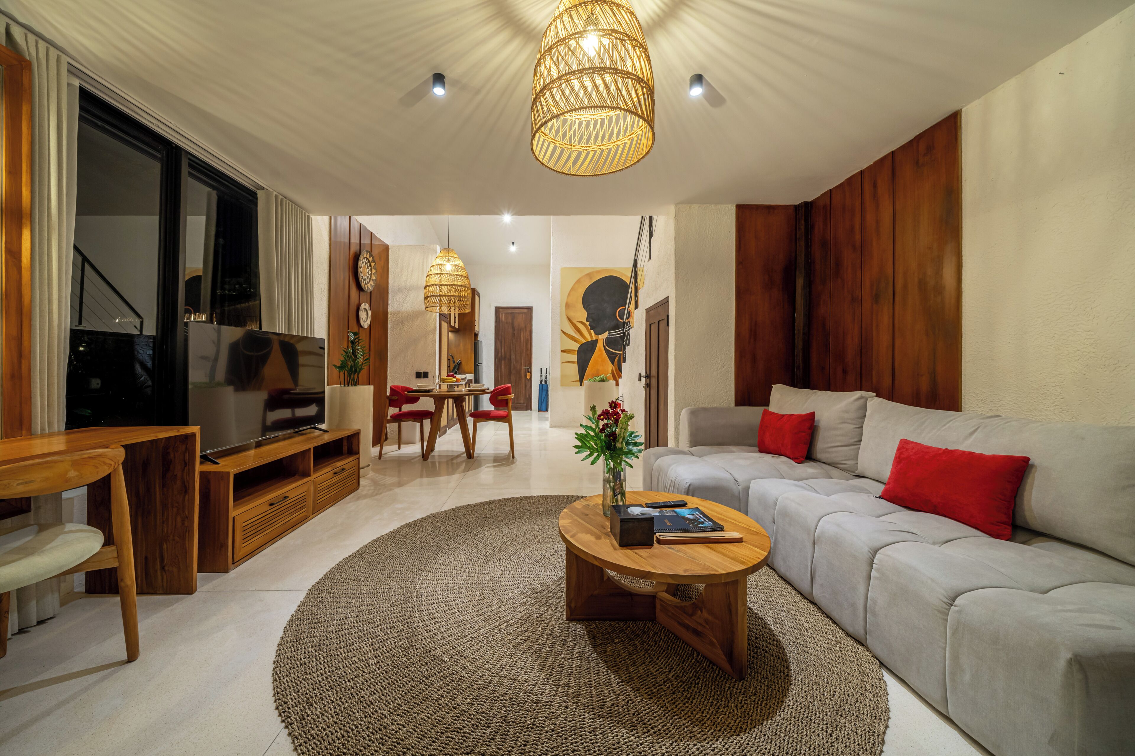 Una sala de estar moderna con sofá, mesa de centro y televisor.