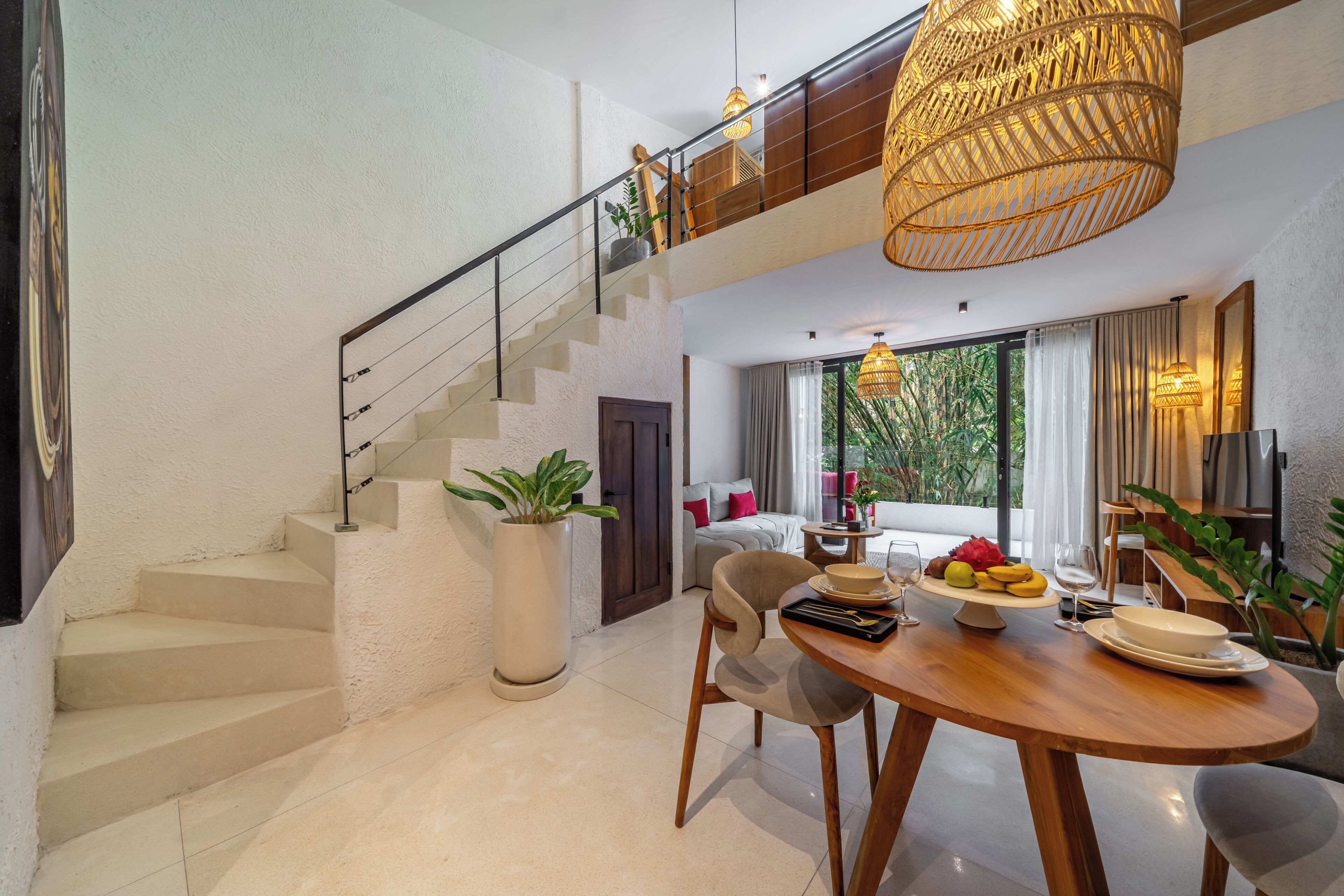 A modern interior with a staircase, a dining area, and a living space with a view.