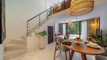 A modern interior with a staircase, a dining area, and a living space with a view.