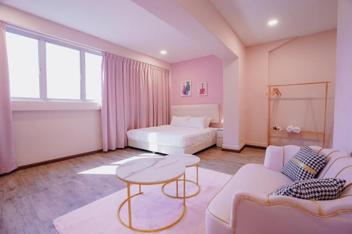 A bedroom with a bed, bedside tables, a wardrobe, and a window with curtains.