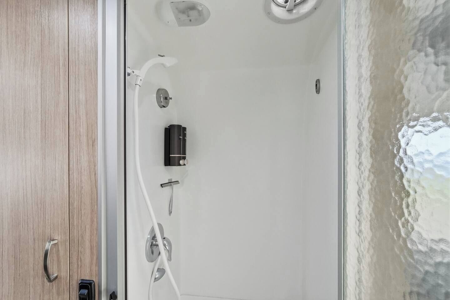 A bathroom with a shower, a toilet, and a sink.