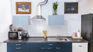 A kitchen with a microwave, toaster, sink, cabinet, and a stainless steel range hood. - Nobile Studio in the Historic Town, Koper, Slovenia (Koper)