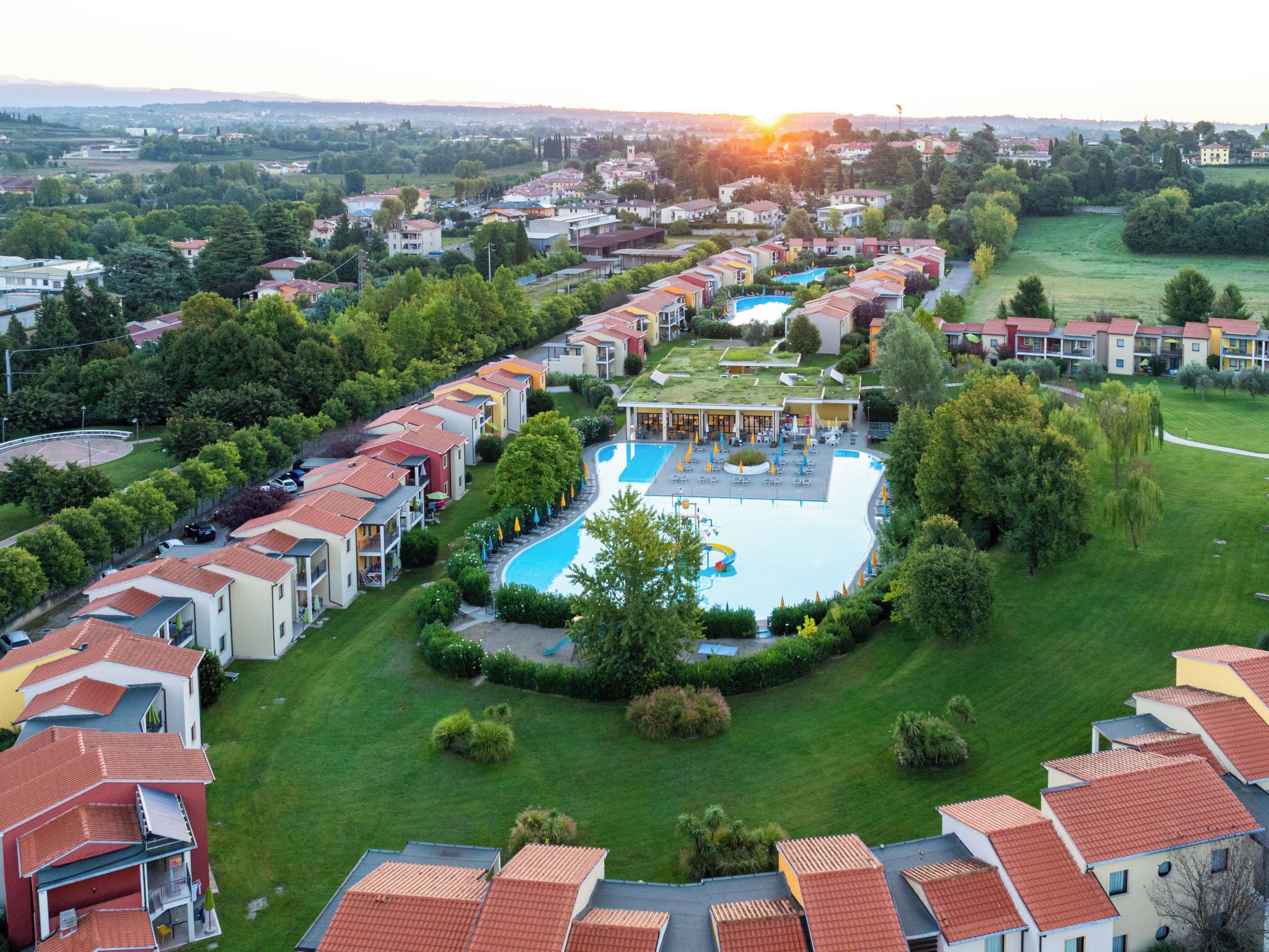 A residential area with a swimming pool surrounded by houses.