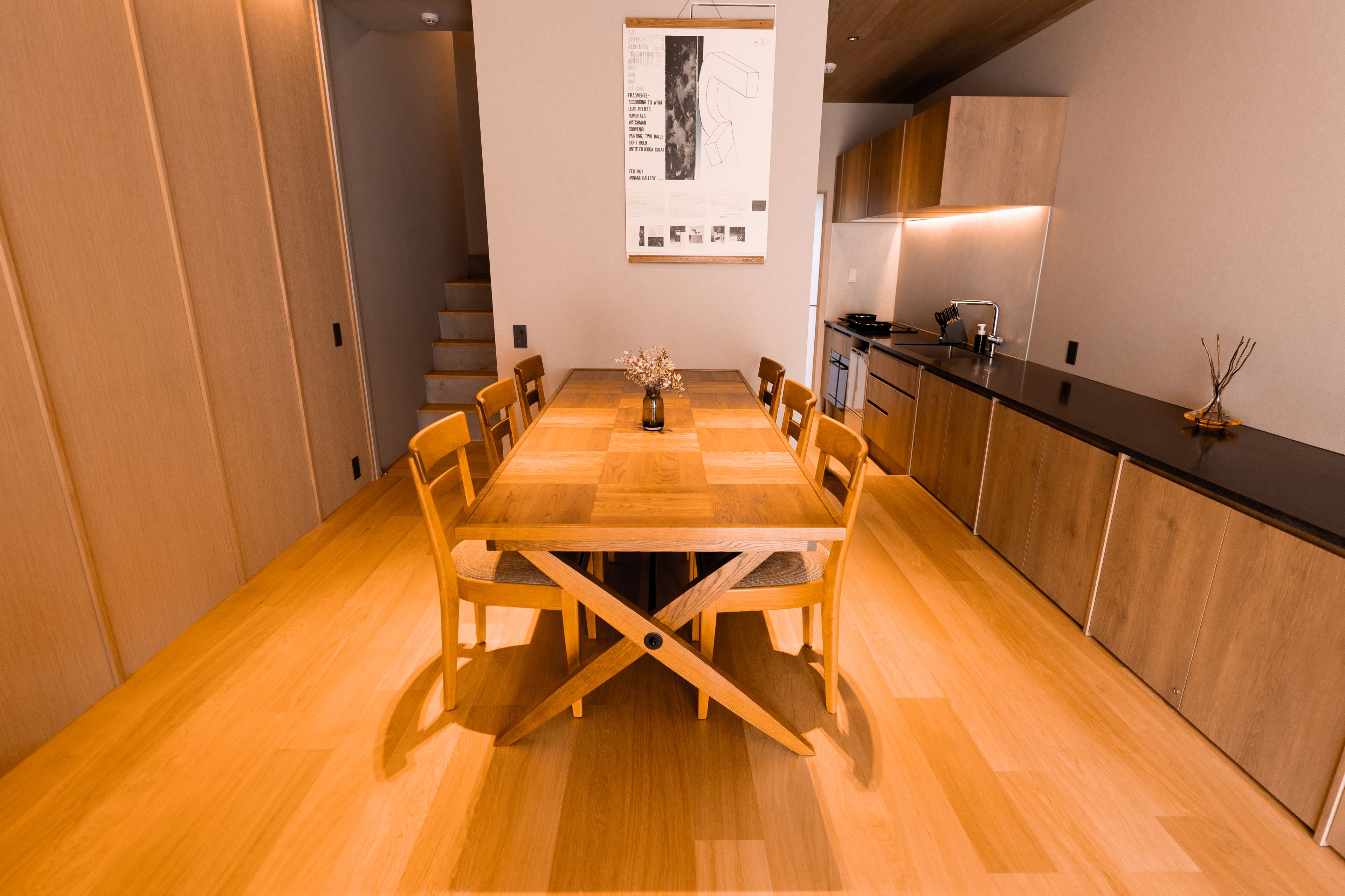 A modern kitchen with wooden cabinetry and a black countertop.
