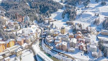A snow-covered town with a mix of residential and commercial buildings, including a prominent church with a dome.
