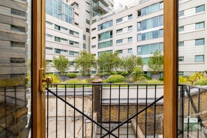 A modern building with multiple floors, large windows, and a gated entrance. - Brick & Beam on Tabard (London)