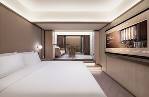 A hotel room with a large bed, a TV mounted on the wall, and a view of the hotel's interior. - Crystal Hotel BJ Guomao Jianguomen CBD (Beijing)
