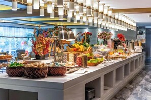 A buffet setup with various food items and decorations. - MEHOOD LESTIE Hotel (Nanchang Tengwang Pavilion) (Nanchang)