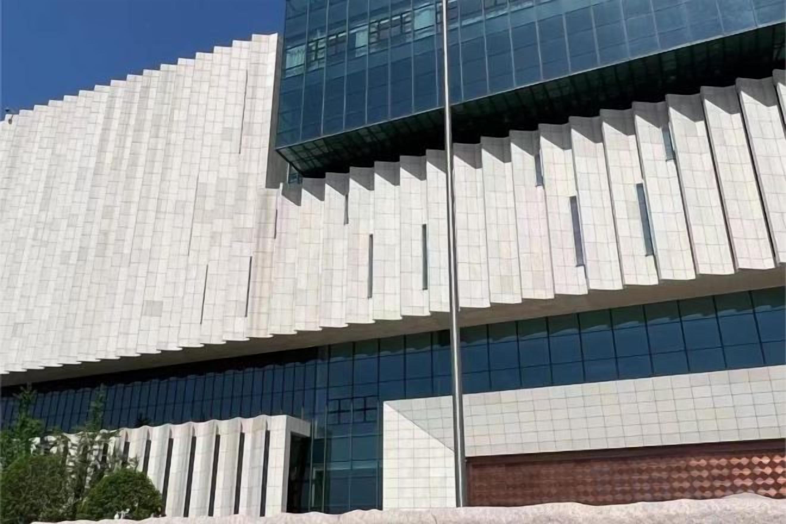 A modern building with a distinctive geometric facade and large windows.