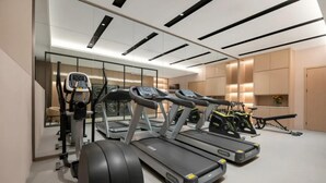 A modern gym with treadmills, a stationary bike, and a rowing machine. - Jinjiang Inn (Wuhan)