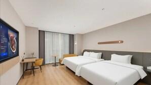 A hotel room with two beds, a desk, a chair, a TV, and a window with curtains. - Jinjiang Inn (Wuhan)