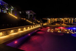 A nighttime view of a resort with a swimming pool, outdoor seating, and a well-lit pathway. - Pool, Yoga Studio -Private La Vibra Resort Villa 4 (Langostino)