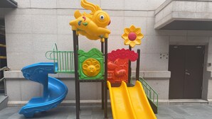 A playground with a blue slide, a yellow slide, and a climbing structure with animal figures. -  Crystal Orange Hotel, Beijing Qianmen (Beijing)