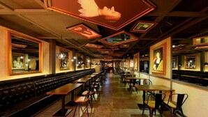 A restaurant interior with long communal tables, individual booths, and framed artwork on the walls. -  Crystal Orange Hotel, Beijing Qianmen (Beijing)