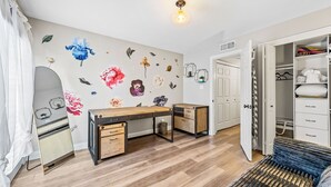 A room with a wooden desk, a wardrobe, and a bed with a white duvet. - NEW Gorgeous Townhome, Beautiful Balcony, Centrally Located at 44th St/Camelback (Phoenix)