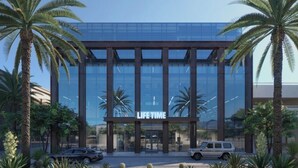 A modern building with a glass facade and the sign 'LIFE TIME' at the entrance. - NEW Gorgeous Townhome, Beautiful Balcony, Centrally Located at 44th St/Camelback (Phoenix)
