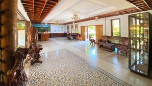 A spacious lobby with a high ceiling, patterned floor tiles, and a reception desk. - ASANA (Siem Reap)