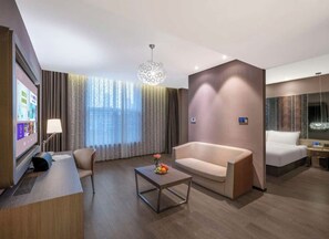 A hotel room with a desk, a sofa, a bed, and a large window with curtains. - Crystal  Hotel Tianjin Jinwan Plaza (Tianjin)