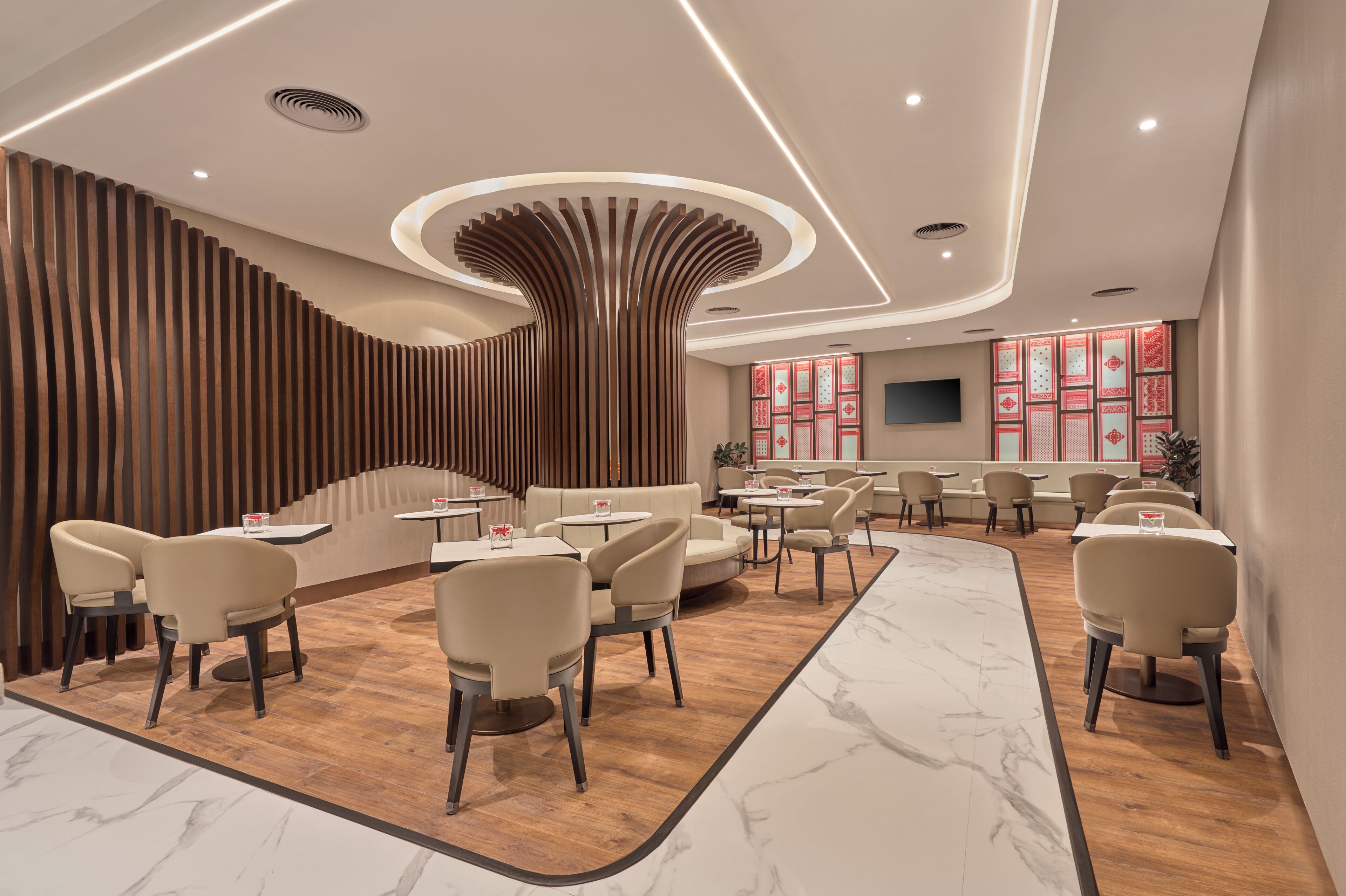 A modern interior with a curved wooden wall, seating area, and a bar.