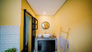 A bathroom with a bathtub, a sink, and a mirror.
